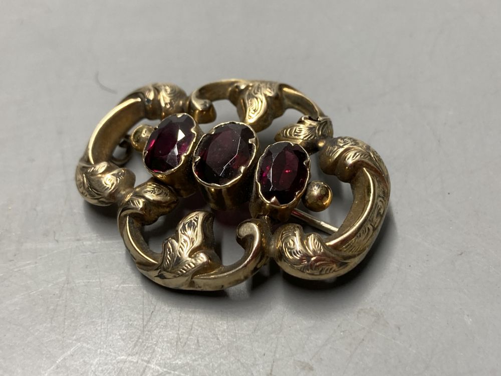 Two gold plated overlaid and gem set fob seals, largest 35mm, a 9ct front and back locket and a scroll brooch.